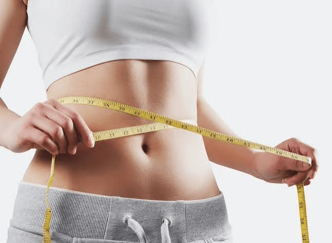 Woman Measuring Waist with Yellow Tape for Medical Weight Loss